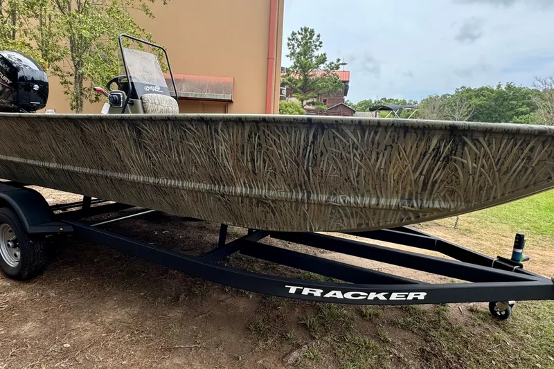 The Image of 2026 Tracker Grizzly 2072 CC boat with camouflage design on a trailer. - 0