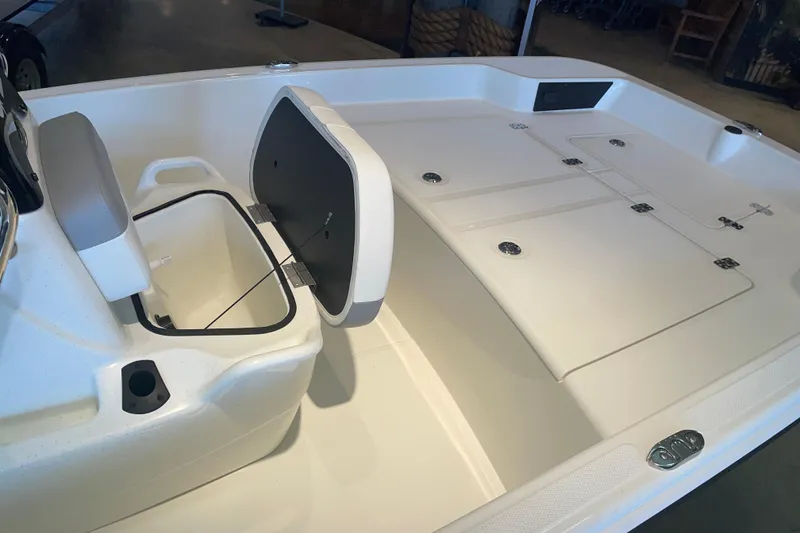 Slide: The Image of 2026 Mako Pro Skiff 15 CC boat interior with open storage compartment and seating. - 5