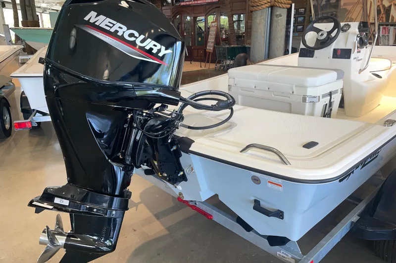 Slide: The Image of 2026 Mako Pro Skiff 15 CC with Mercury outboard motor in showroom. - 4