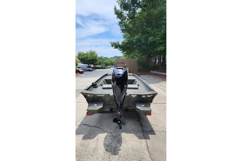 Slide: The Image of 2026 Tracker Grizzly 2072 CC boat, rear view, parked outdoors on a sunny day. - 3