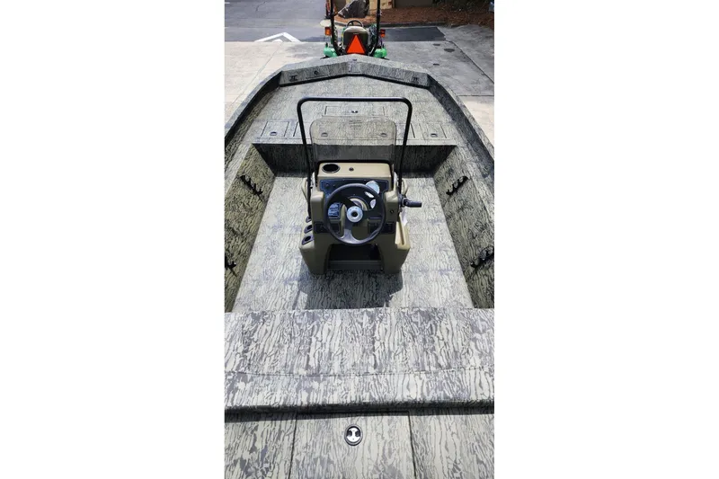 Slide: The Image of 2026 Tracker Grizzly 2072 CC boat interior with camouflage design and steering console. - 5