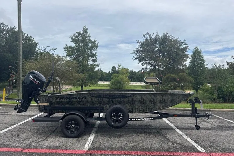 The Image of 2026 Tracker Grizzly 1650 T Prairie Wings Edition boat on trailer in parking lot. - 0