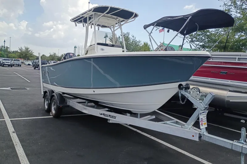 The Image of 2026 Mako 214 Center Console boat on trailer in parking lot. - 0