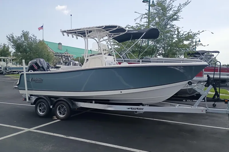 Slide: The Image of 2026 Mako 214 Center Console boat on trailer in parking lot. - 1