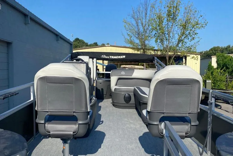 Slide: The Image of 2026 Sun Tracker Bass Buggy 18 DLX pontoon boat interior with seating and canopy. - 8