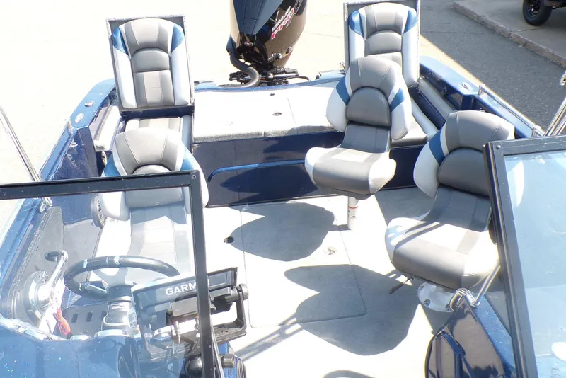 Slide: The Image of 2026 Nitro ZV19 Sport Pro boat interior with seating and steering console. - 6