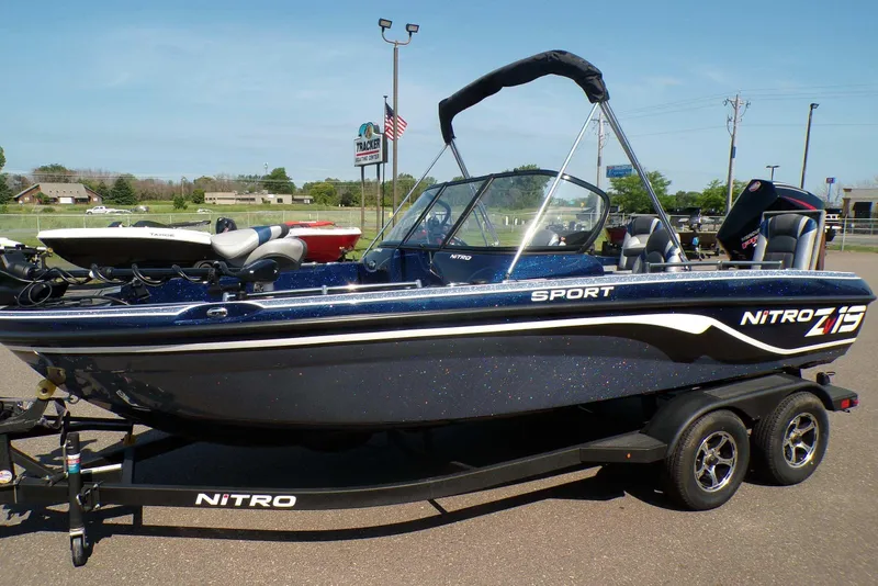 The Image of 2026 Nitro ZV19 Sport Pro boat on trailer, parked outdoors under clear sky. - 0