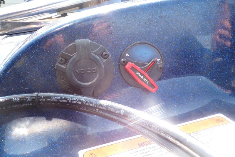 Slide: The Image of Close-up of Nitro ZV19 Sport Pro 2026 boat controls, featuring a drain plug and NOCO cap. - 7