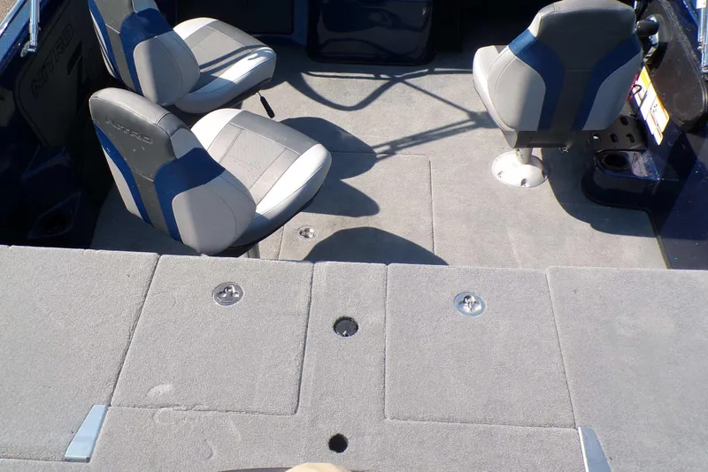Slide: The Image of Interior of 2026 Nitro ZV19 Sport Pro boat with gray seating and carpeted flooring. - 4