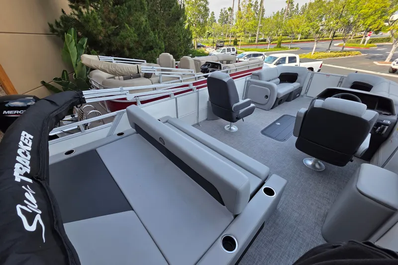 Slide: The Image of 2026 Sun Tracker Party Barge 22 RF XP3 interior with seating and steering console. - 2