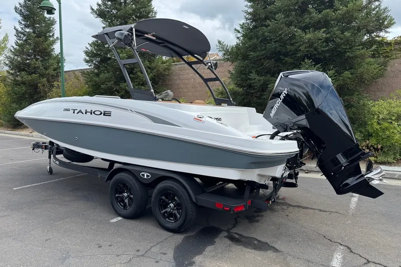 Slide: The Image of 2026 Tahoe 2150 boat on trailer, parked outdoors, featuring a Mercury outboard motor. - 1