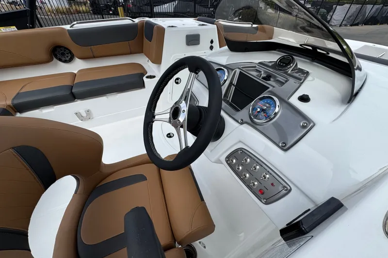 Slide: The Image of Interior of a 2026 Tahoe 2150 boat featuring modern dashboard and seating. - 13
