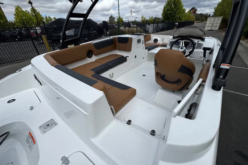 Slide: The Image of 2026 Tahoe 2150 boat interior with brown seating and modern dashboard. - 10