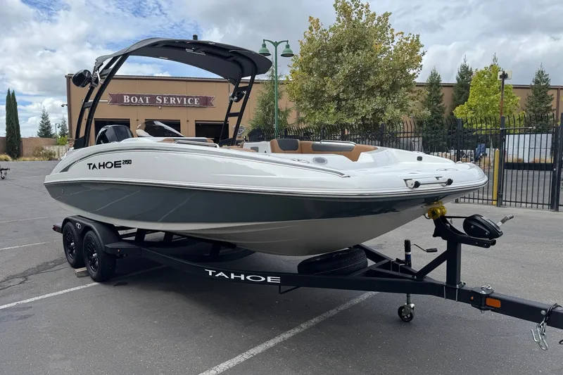 Slide: The Image of 2026 Tahoe 2150 boat on trailer in front of boat service building. - 3