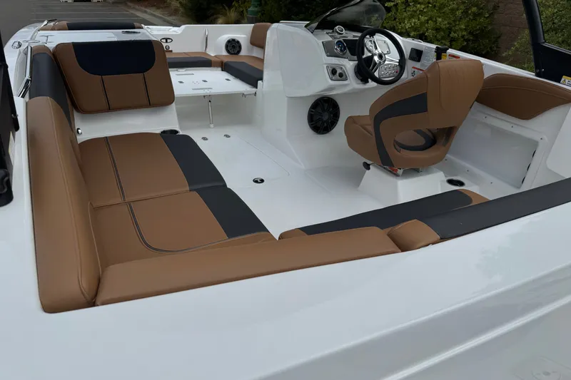Slide: The Image of Interior of 2026 Tahoe 2150 boat with brown and black seating, modern dashboard. - 8