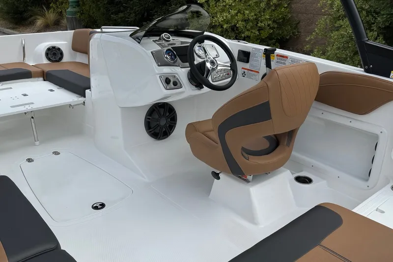 Slide: The Image of Interior of 2026 Tahoe 2150 boat with brown and black seating, modern dashboard. - 9
