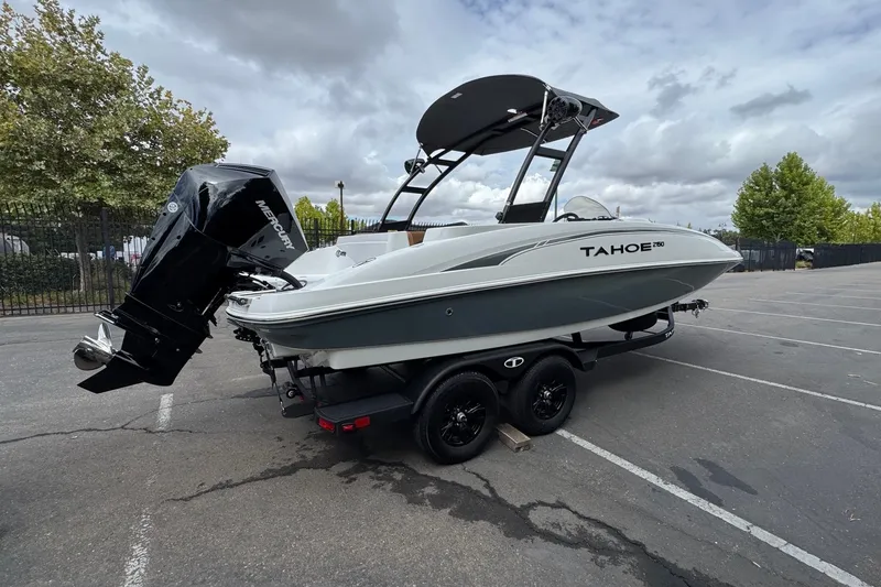 Slide: The Image of 2026 Tahoe 2150 boat on trailer with Mercury outboard motor in parking lot. - 5