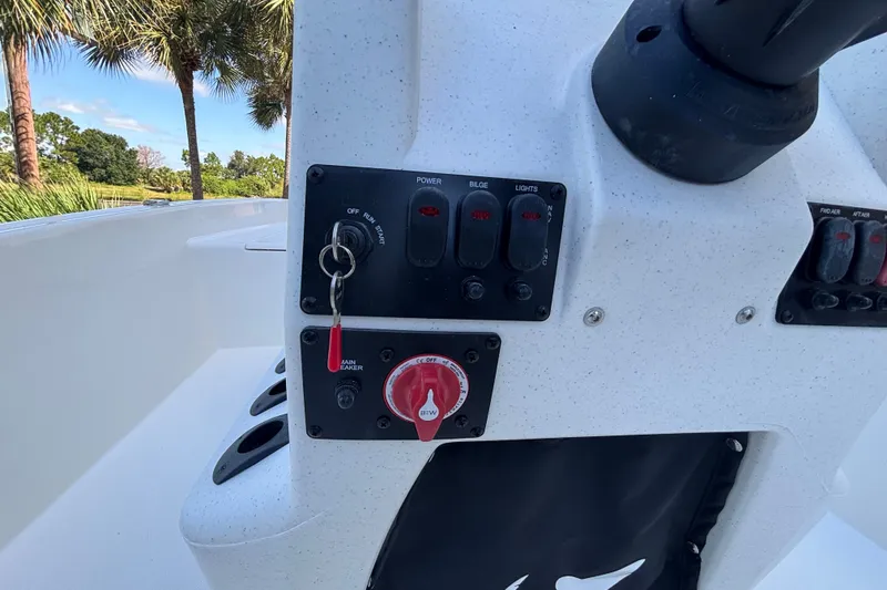 Slide: The Image of Control panel of 2026 Mako Pro Skiff 17 CC boat with switches and key ignition. - 52