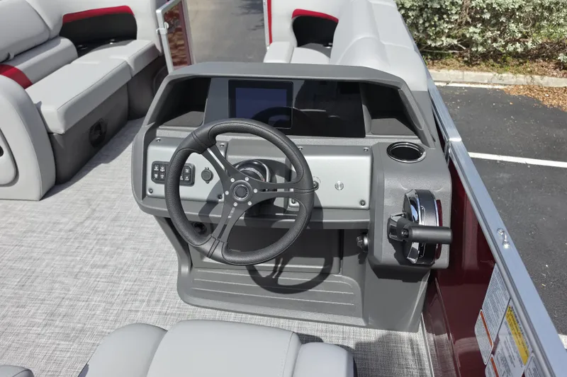 Slide: The Image of 2026 Sun Tracker Party Barge 22 RF DLX helm with steering wheel and controls. - 8