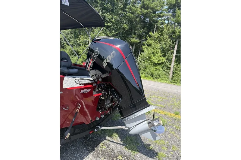 Slide: The Image of 2026 Tracker Targa V-19 WT boat with powerful 200 HP engine, parked outdoors. - 8