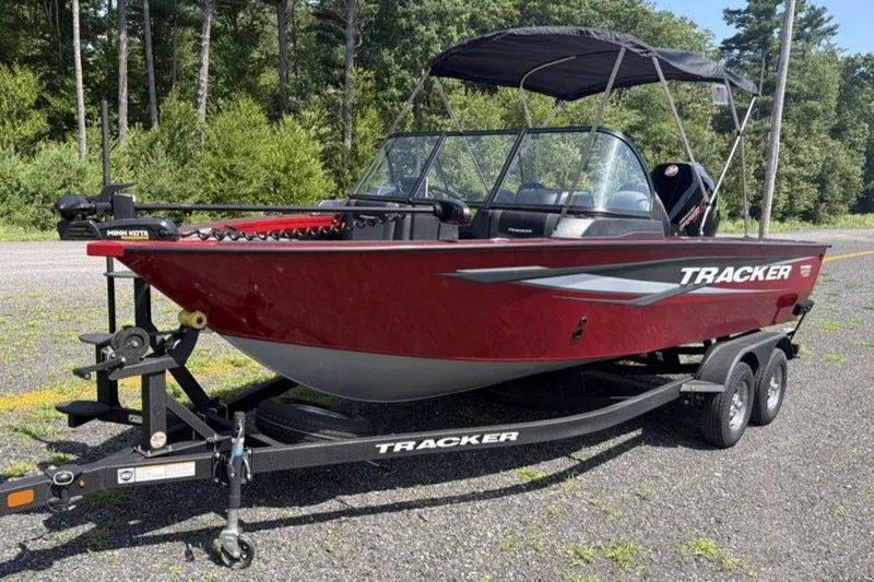 The Image of 2026 Tracker Targa V-19 WT boat on trailer, red exterior, parked outdoors. - 0