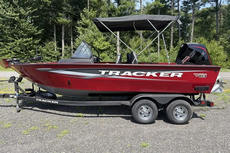 Slide: The Image of 2026 Tracker Targa V-19 WT boat on trailer, red with canopy, parked outdoors. - 2