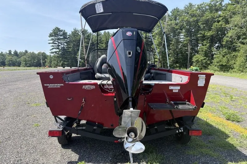 Slide: The Image of 2026 Tracker Targa V-19 WT boat, rear view with outboard motor, parked outdoors. - 7