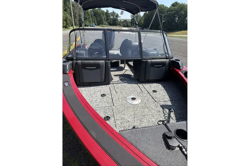 Slide: The Image of 2026 Tracker Targa V-19 WT boat interior with seating and windshield, parked outdoors. - 10