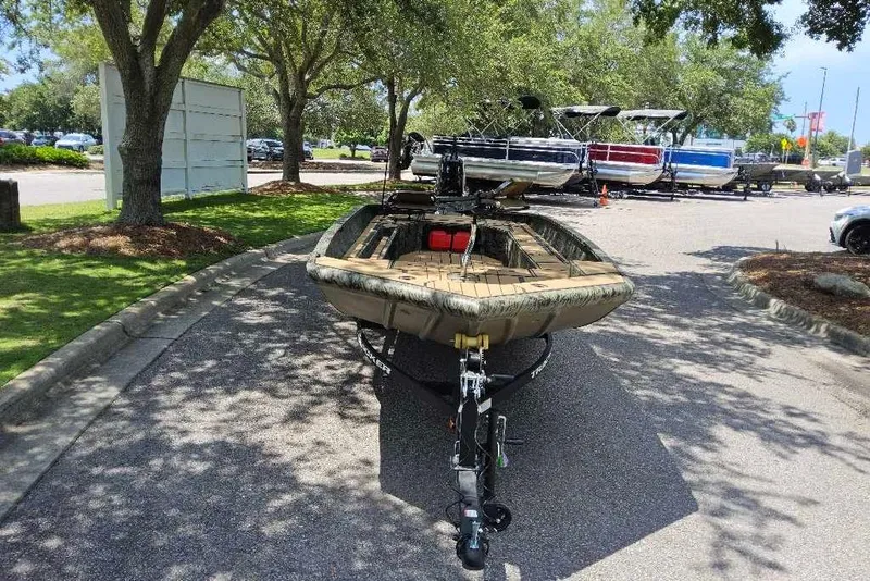 Slide: The Image of 2026 Tracker Grizzly 1756 T Marsh boat on trailer in sunny outdoor setting. - 7