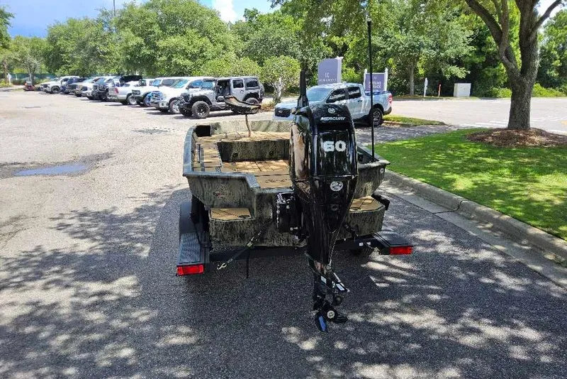 Slide: The Image of 2026 Tracker Grizzly 1756 T Marsh boat with Mercury 60 engine in parking lot. - 6