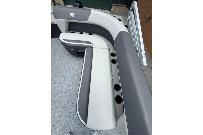 Slide: The Image of 2026 Sun Tracker Bass Buggy 16 XL Select boat seating with cup holders, gray and white upholstery. - 2
