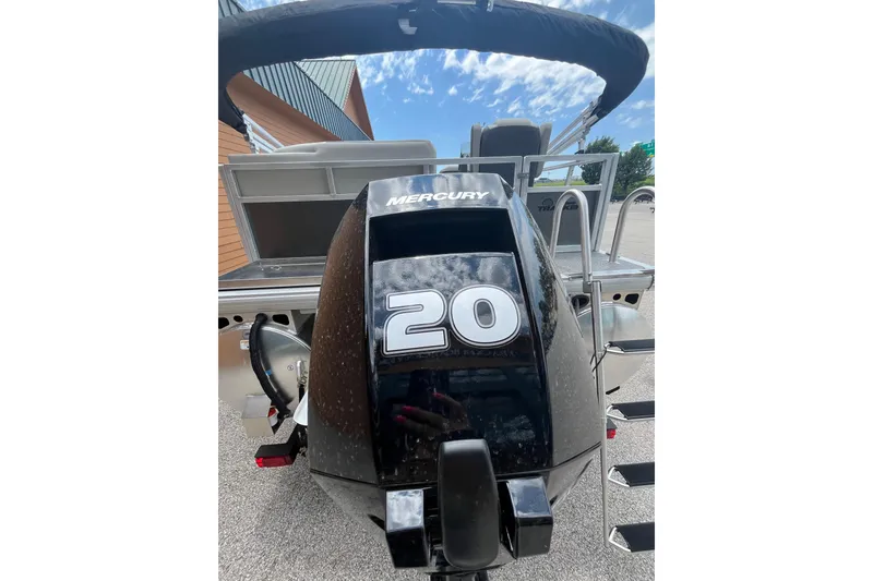 Slide: The Image of 2026 Sun Tracker Bass Buggy 16 XL Select with Mercury 20 HP engine, outdoor view. - 6