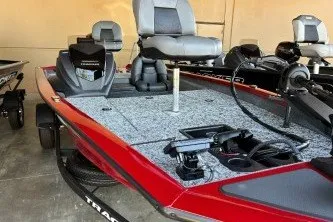 The Image of 2026 Tracker Pro Team 175 boat with red exterior and gray seating. - 0