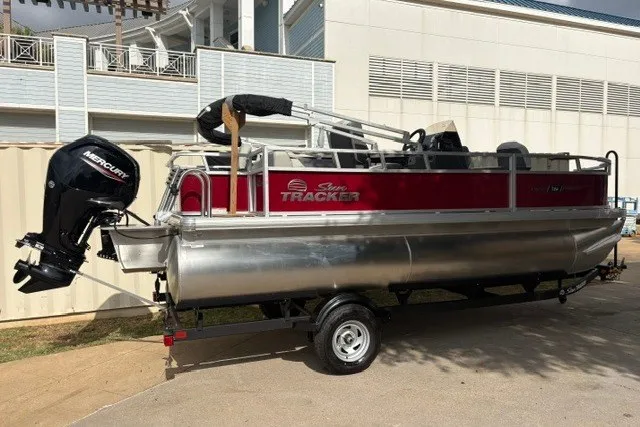Slide: The Image of 2026 Sun Tracker Bass Buggy 18 DLX pontoon boat on trailer, featuring Mercury outboard motor. - 15