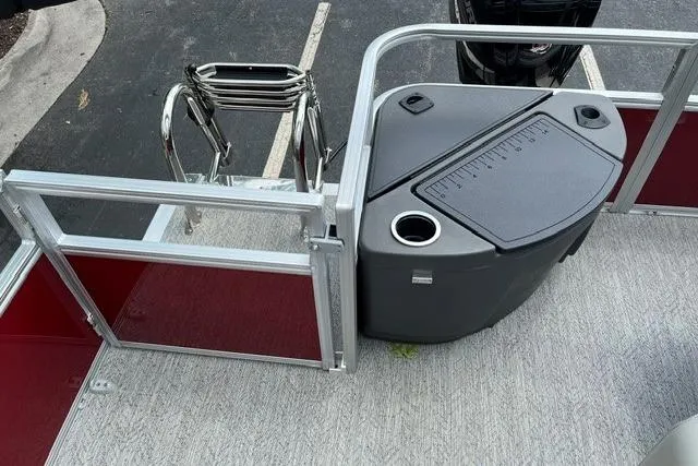 Slide: The Image of 2026 Sun Tracker Bass Buggy 18 DLX pontoon boat interior with seating and storage. - 14