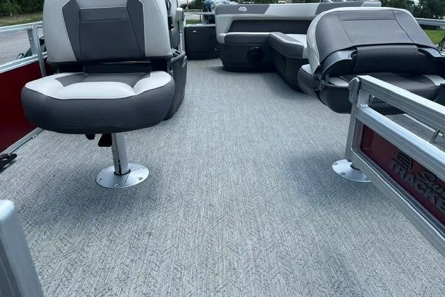 Slide: The Image of 2026 Sun Tracker Bass Buggy 18 DLX interior with gray seating and carpeted deck. - 4
