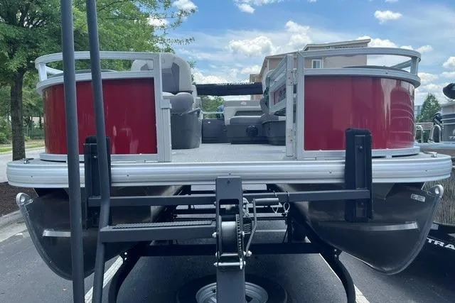 Slide: The Image of 2026 Sun Tracker Bass Buggy 18 DLX pontoon boat on trailer, rear view. - 3