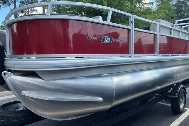Slide: The Image of 2026 Sun Tracker Bass Buggy 18 DLX pontoon boat with red exterior on a trailer. - 2