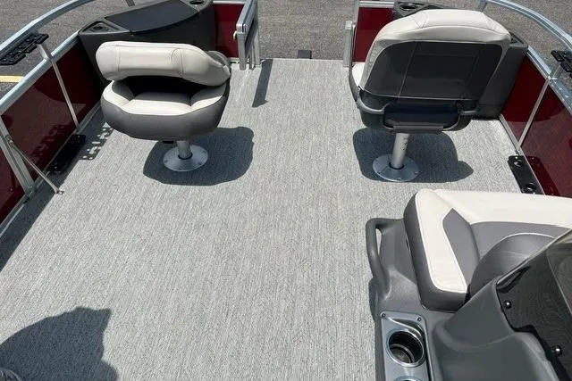 Slide: The Image of 2026 Sun Tracker Bass Buggy 18 DLX pontoon boat interior with seating and carpeted deck. - 11