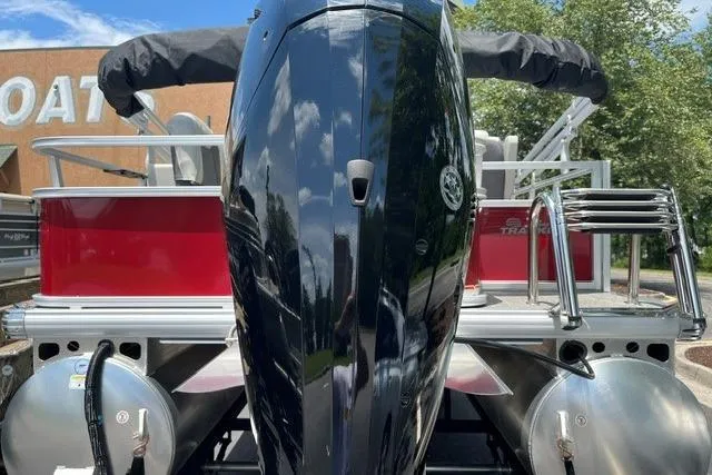 Slide: The Image of 2026 Sun Tracker Bass Buggy 18 DLX pontoon boat with outboard motor, rear view. - 6