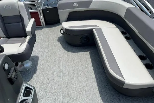 Slide: The Image of 2026 Sun Tracker Bass Buggy 18 DLX interior with gray seating and carpeted floor. - 7