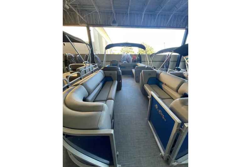 Slide: The Image of 2026 Sun Tracker Party Barge 20 DLX interior with spacious seating under canopy. - 2