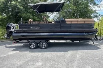 The Image of 2026 Ranger 223FC pontoon boat on trailer, parked outdoors. - 0