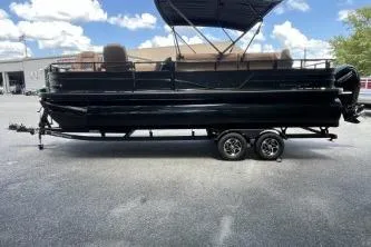 Slide: The Image of 2026 Ranger 223FC pontoon boat on trailer under blue sky. - 2