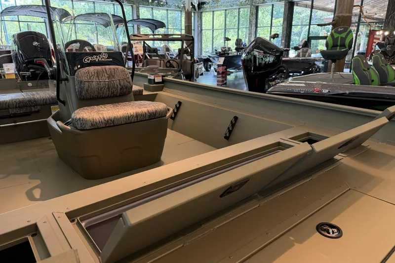 Slide: The Image of 2026 Tracker Grizzly 2072 CC boat interior with seating and storage compartments. - 3