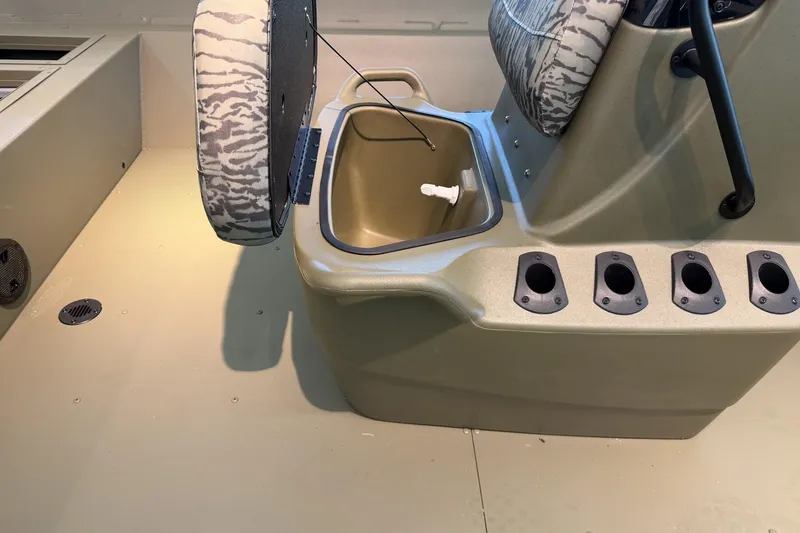 Slide: The Image of 2026 Tracker Grizzly 2072 CC boat interior with storage compartment and rod holders. - 7