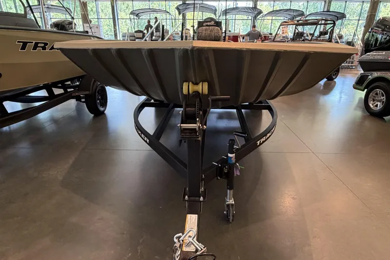 Slide: The Image of 2026 Tracker Grizzly 2072 CC boat on trailer in showroom, front view. - 5