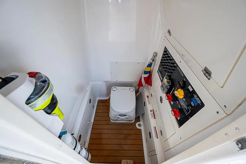 Slide: The Image of 2020 Caymas 28 HB boat interior with control panel and portable toilet. - 22