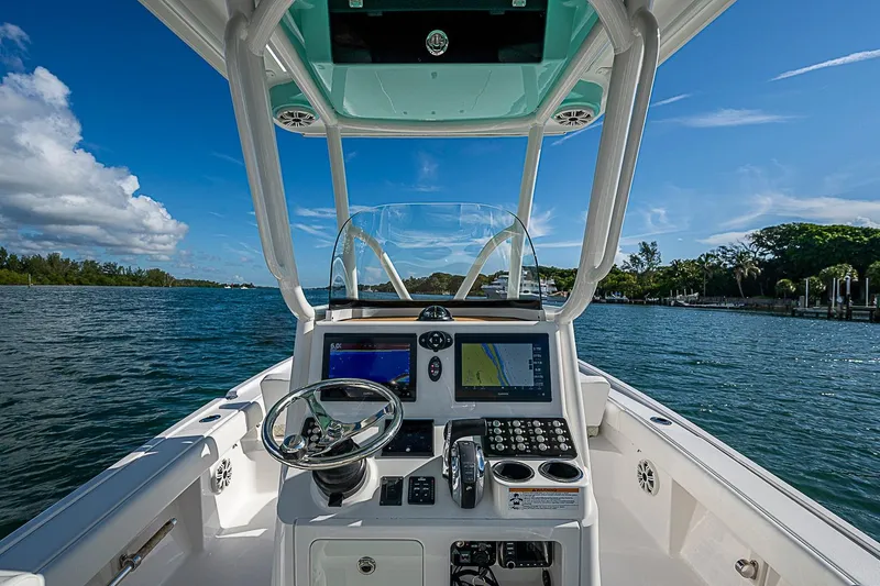 Slide: The Image of Cockpit view of 2020 Caymas 28 HB boat with navigation screens and steering wheel. - 23