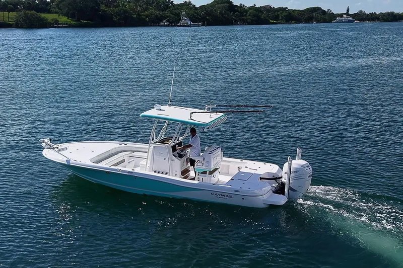 Slide: The Image of 2020 Caymas 28 HB boat cruising on a serene lake under clear skies. - 3